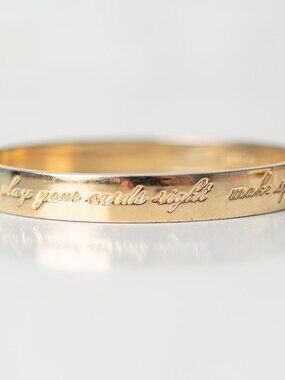 Kate Spade New York Idiom Gold Tone Bangle Bracelet Engraved Quote